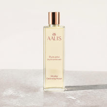 AALIS Dayana Micellar Cleansing Water bottle shown next to fresh water droplets.